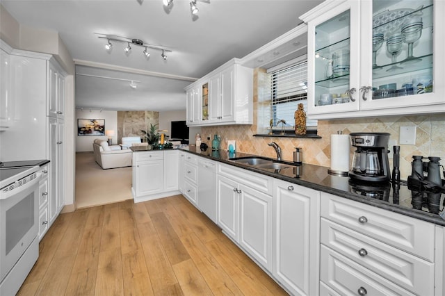 kitchen featuring white cabinetry, light hardwood / wood-style flooring, white stove, and sink