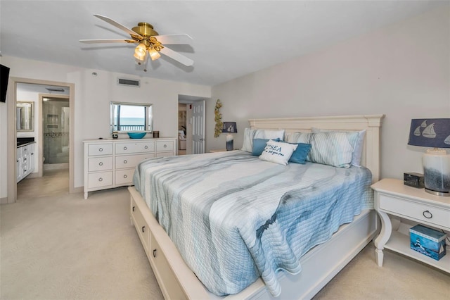 carpeted bedroom with connected bathroom and ceiling fan