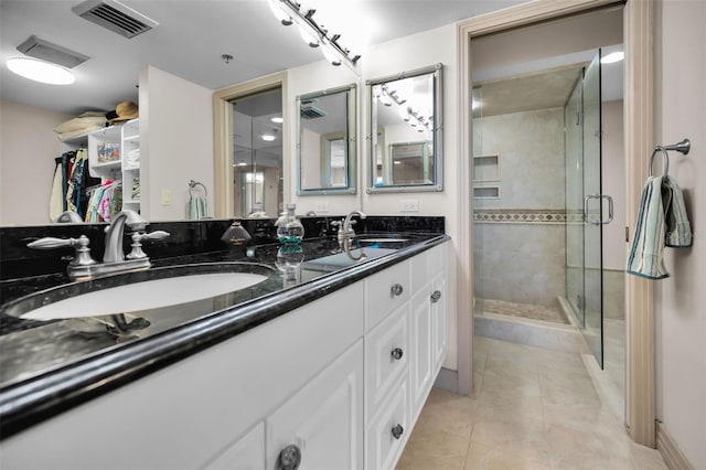 bathroom with tile patterned flooring, vanity, and an enclosed shower