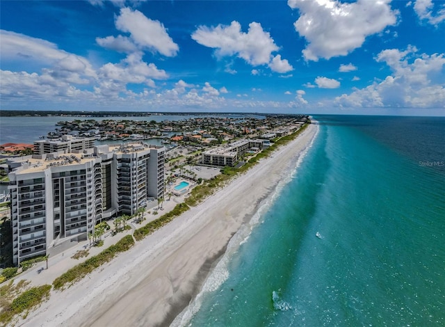 aerial view with a water view and a beach view