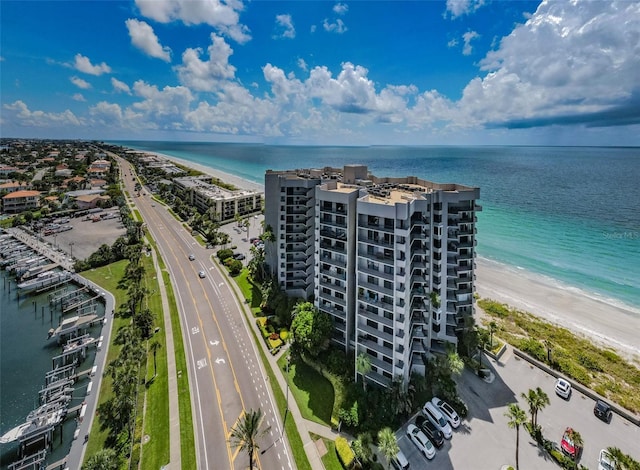 drone / aerial view with a beach view and a water view