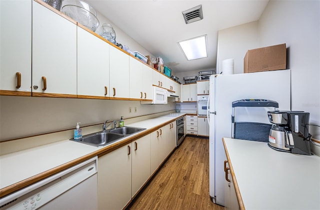 kitchen featuring light hardwood / wood-style flooring, white cabinets, white appliances, and sink