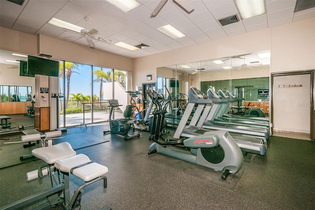 workout area with ceiling fan and a drop ceiling