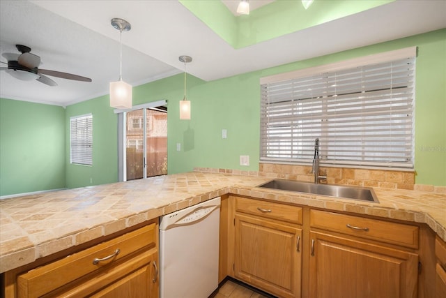 kitchen with white dishwasher, sink, hanging light fixtures, ceiling fan, and kitchen peninsula