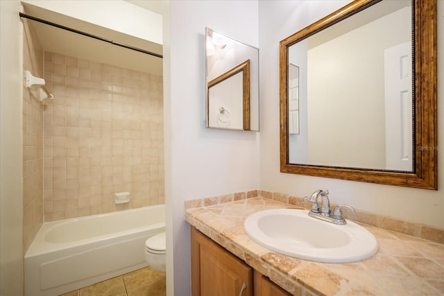 full bathroom with tile patterned flooring, vanity, toilet, and tiled shower / bath