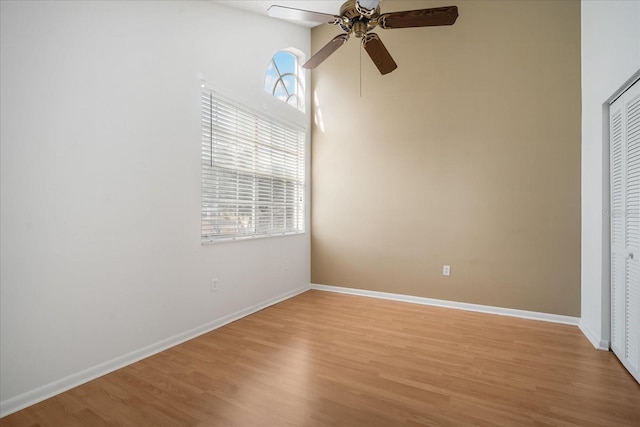 unfurnished bedroom featuring ceiling fan, a closet, and light hardwood / wood-style floors