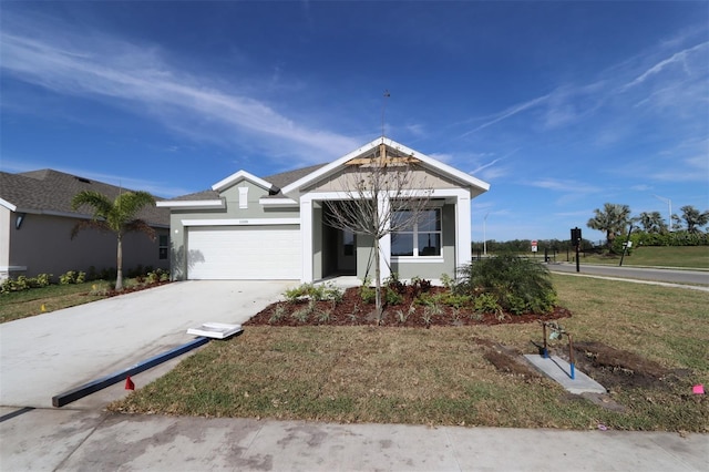 view of front of home with a garage and a front lawn