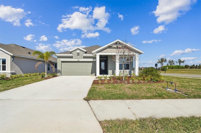 view of front of property with a garage and a front lawn