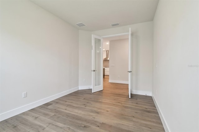 unfurnished room featuring hardwood / wood-style floors