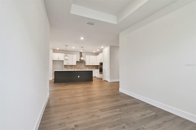 unfurnished living room with light hardwood / wood-style floors