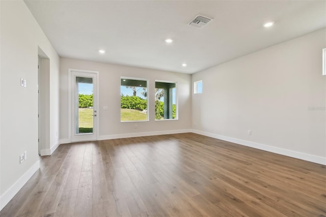 spare room with a healthy amount of sunlight and light wood-type flooring