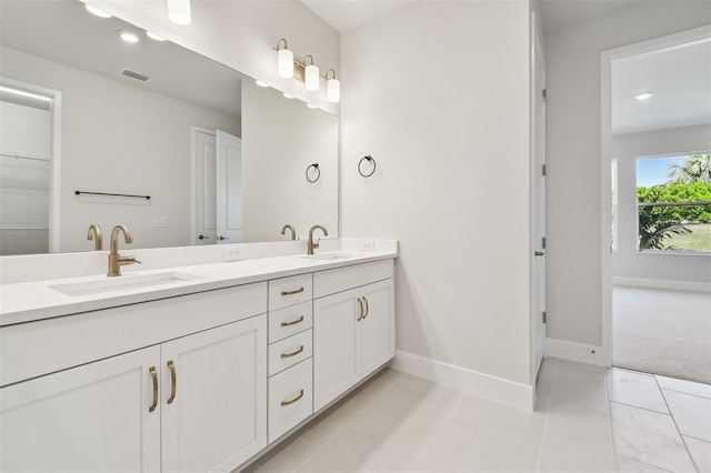 bathroom with tile patterned flooring and vanity