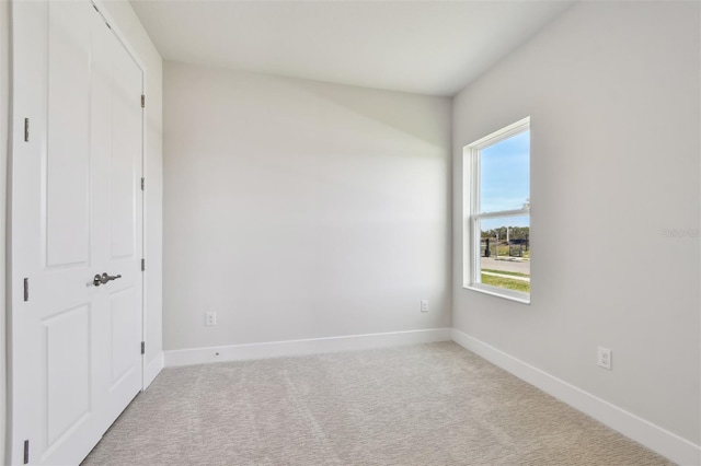 unfurnished bedroom featuring light colored carpet