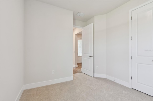 unfurnished room with light carpet