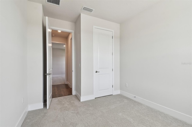 unfurnished bedroom with light carpet