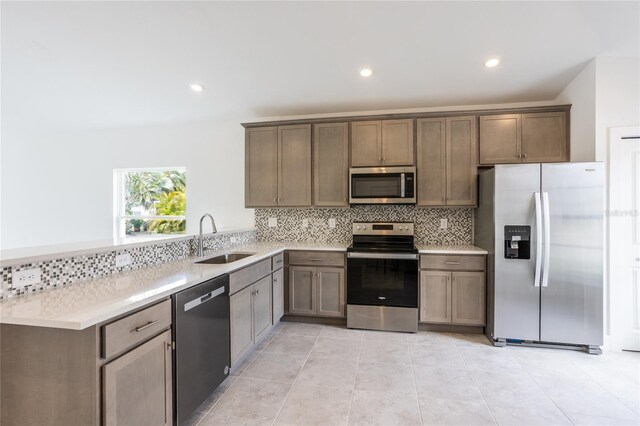 475 Winwood Ct, Port Charlotte, FL 33954 - kitchen featuring stainless steel appliances, a sink, backsplash, a peninsula, and light countertops