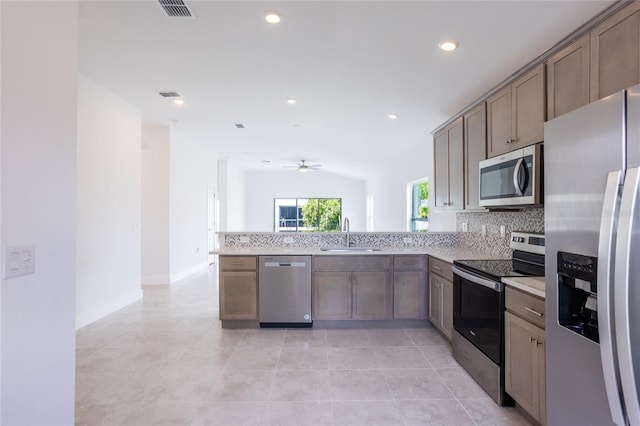 475 Winwood Ct, Port Charlotte, FL 33954 - kitchen with appliances with stainless steel finishes, a sink, tasteful backsplash, a peninsula, and light countertops