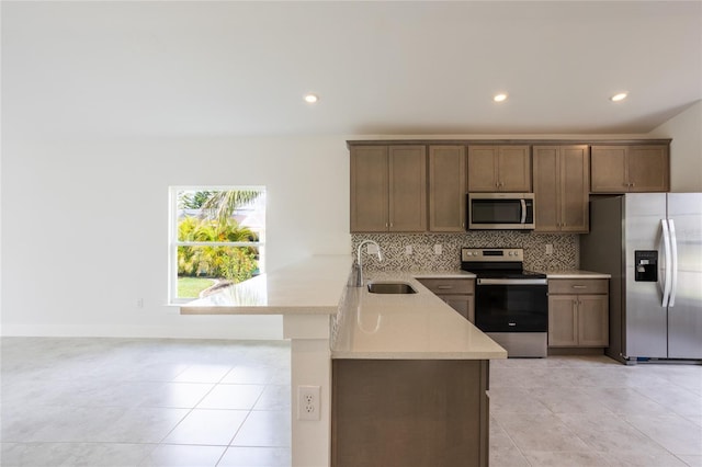 475 Winwood Ct, Port Charlotte, FL 33954 - kitchen featuring stainless steel appliances, a sink, a peninsula, light countertops, and recessed lighting