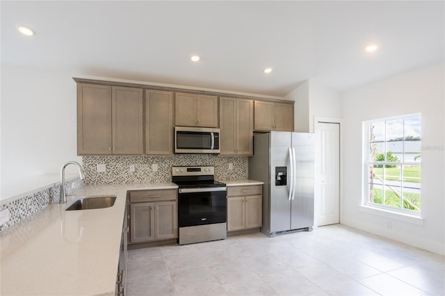 475 Winwood Ct, Port Charlotte, FL 33954 - kitchen with appliances with stainless steel finishes, a sink, backsplash, recessed lighting, and light tile patterned floors
