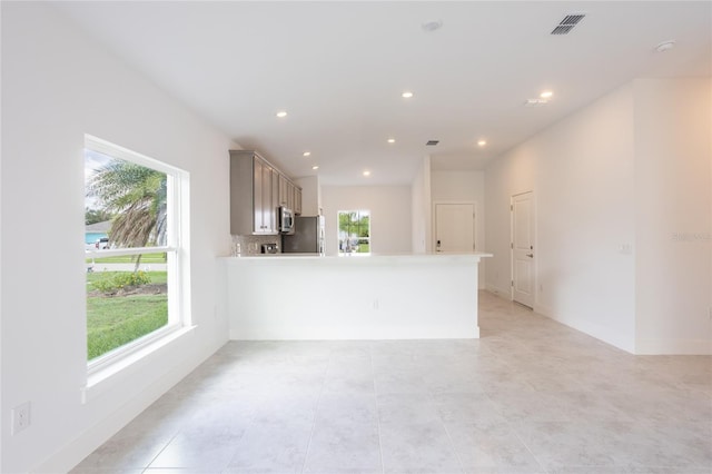 475 Winwood Ct, Port Charlotte, FL 33954 - unfurnished living room featuring healthy amount of natural light, recessed lighting, baseboards, and light tile patterned floors
