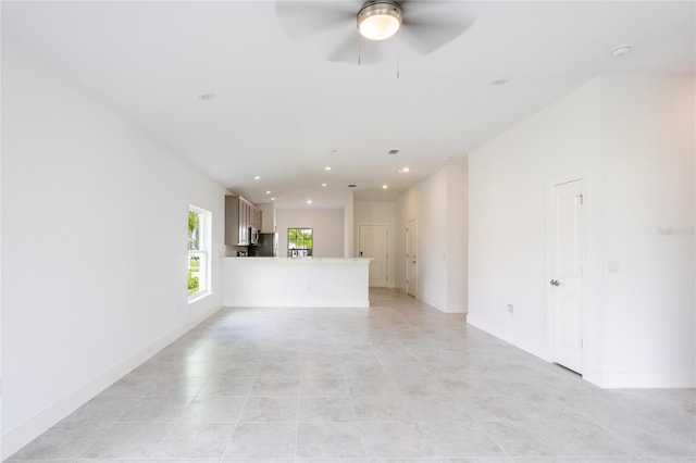 475 Winwood Ct, Port Charlotte, FL 33954 - unfurnished living room with a ceiling fan, recessed lighting, light tile patterned floors, and baseboards