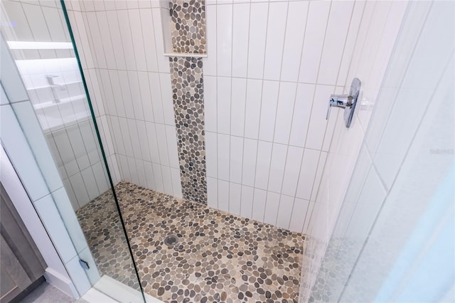 bathroom with a tile shower