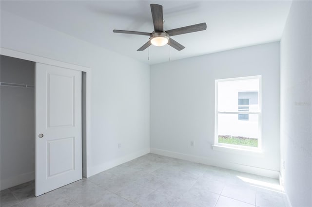 475 Winwood Ct, Port Charlotte, FL 33954 - unfurnished bedroom with a closet, baseboards, light tile patterned flooring, and ceiling fan