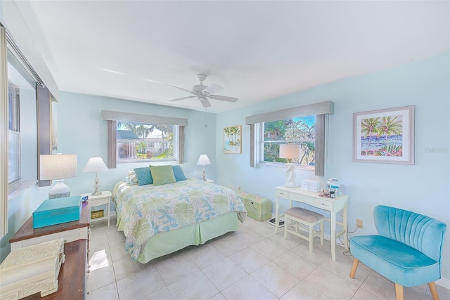 bedroom with light tile patterned floors, multiple windows, and ceiling fan