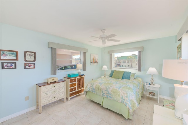 tiled bedroom featuring ceiling fan and multiple windows