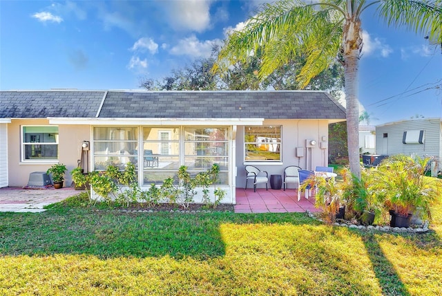 rear view of property with a yard and a patio