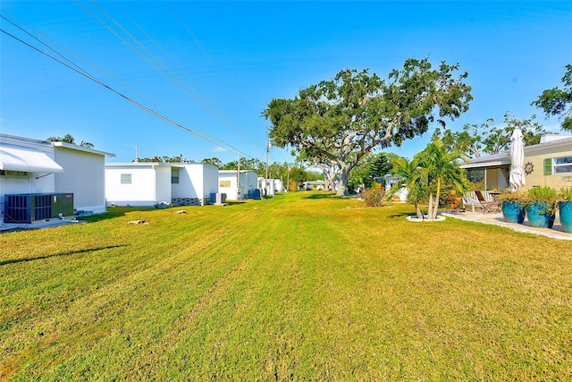 view of yard featuring central air condition unit