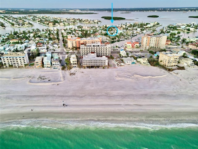 drone / aerial view featuring a water view and a view of the beach