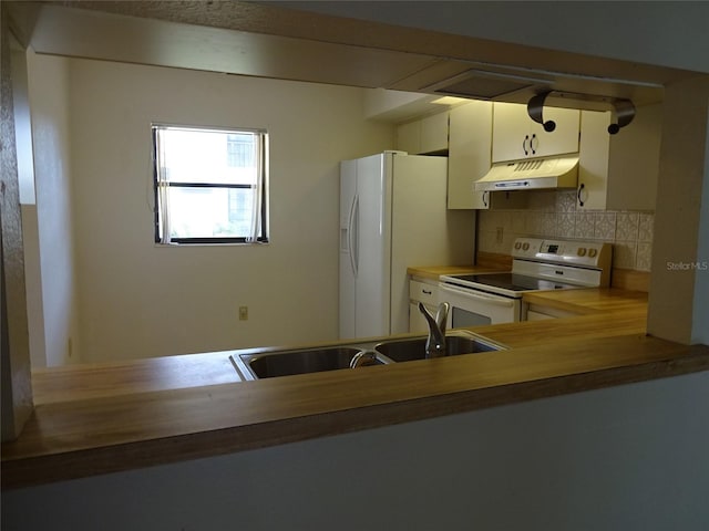 kitchen with white appliances, tasteful backsplash, white cabinetry, and sink