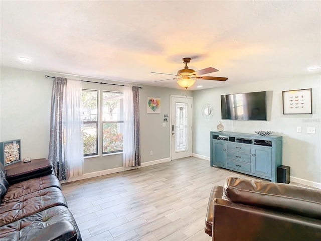 living room with ceiling fan and light hardwood / wood-style floors