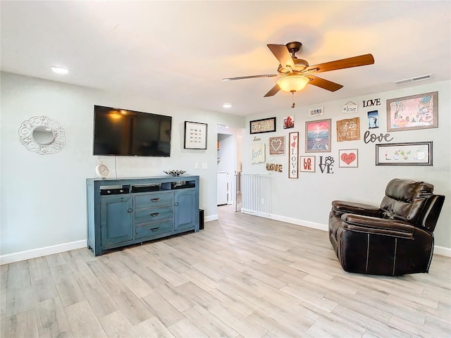 sitting room featuring light hardwood / wood-style floors and ceiling fan