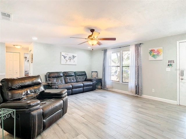 living room featuring ceiling fan and light hardwood / wood-style floors