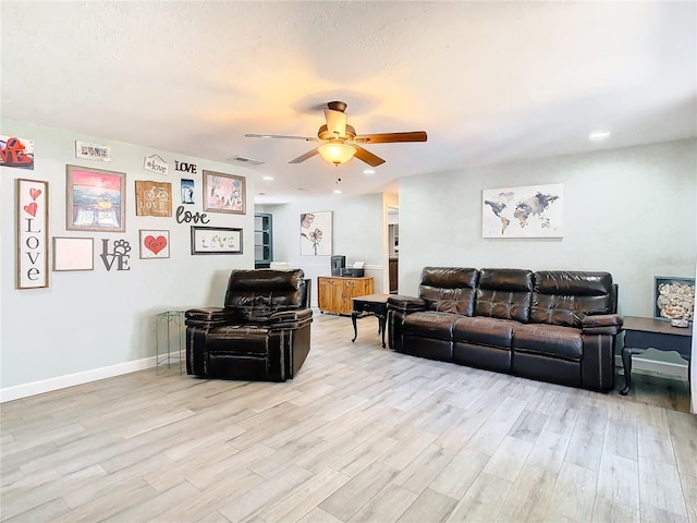 living room featuring ceiling fan and light wood-type flooring