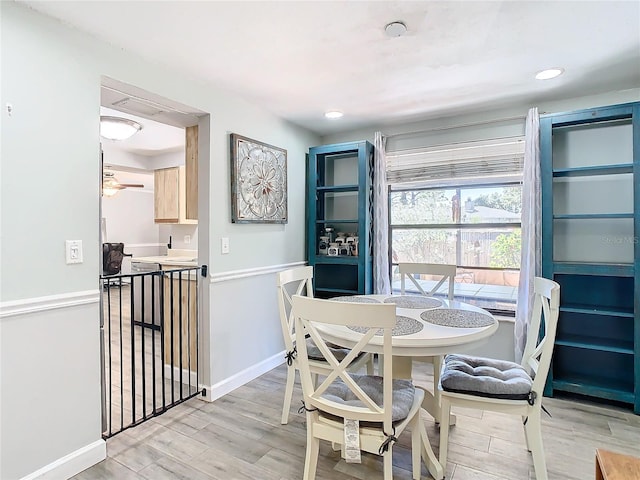 dining area featuring light hardwood / wood-style floors and ceiling fan