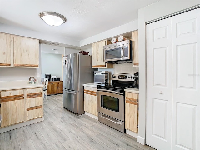 kitchen featuring light hardwood / wood-style floors, stainless steel appliances, and light brown cabinets