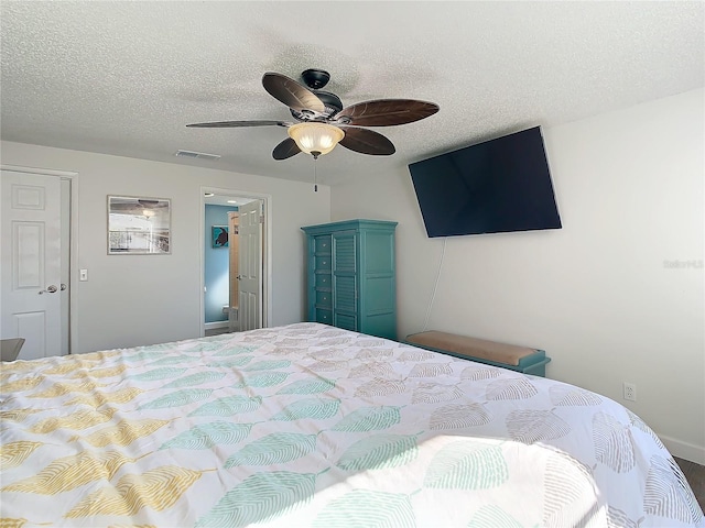 bedroom with a textured ceiling and ceiling fan