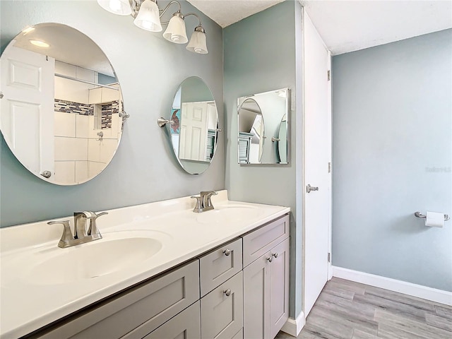 bathroom with hardwood / wood-style flooring and vanity