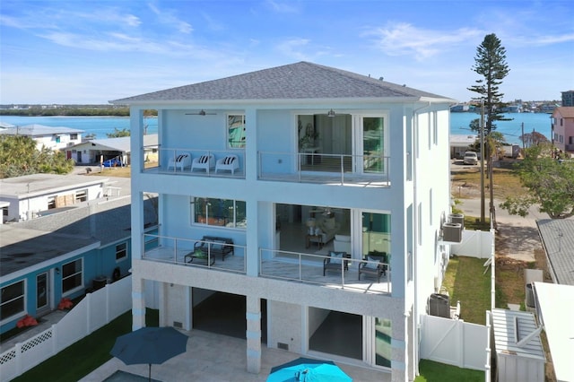 back of property featuring a balcony and a water view