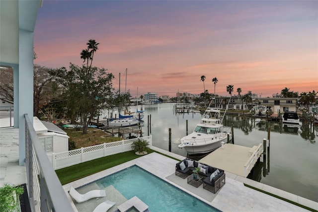 view of dock featuring a patio area, a water view, and a fenced in pool