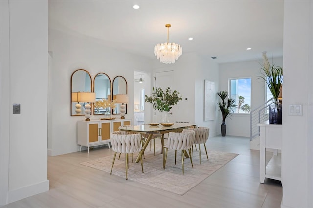 dining area with ceiling fan with notable chandelier