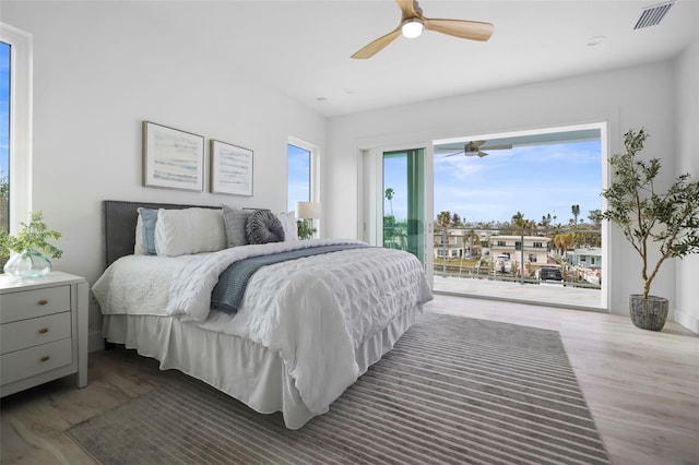 bedroom with access to outside, ceiling fan, and wood-type flooring