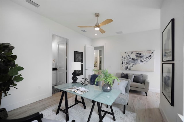 office space with ceiling fan and light hardwood / wood-style flooring