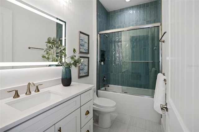 full bathroom featuring shower / bath combination with glass door, tile patterned floors, vanity, and toilet