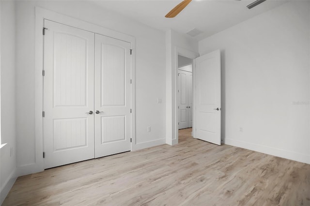 unfurnished bedroom with ceiling fan, light hardwood / wood-style floors, and a closet