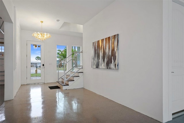 entryway with a chandelier