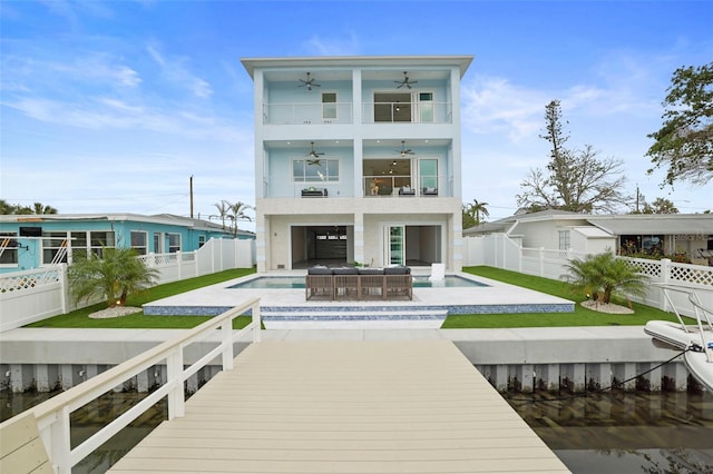 back of house with ceiling fan, a pool with hot tub, an outdoor hangout area, a balcony, and a patio